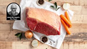 Goodbye, 2020 5 Raw corned beef silverside on butcher’s paper with carrots, onions, bay leaves, cloves and peppercorns, alongside a portrait of meat expert Tom Cooper.