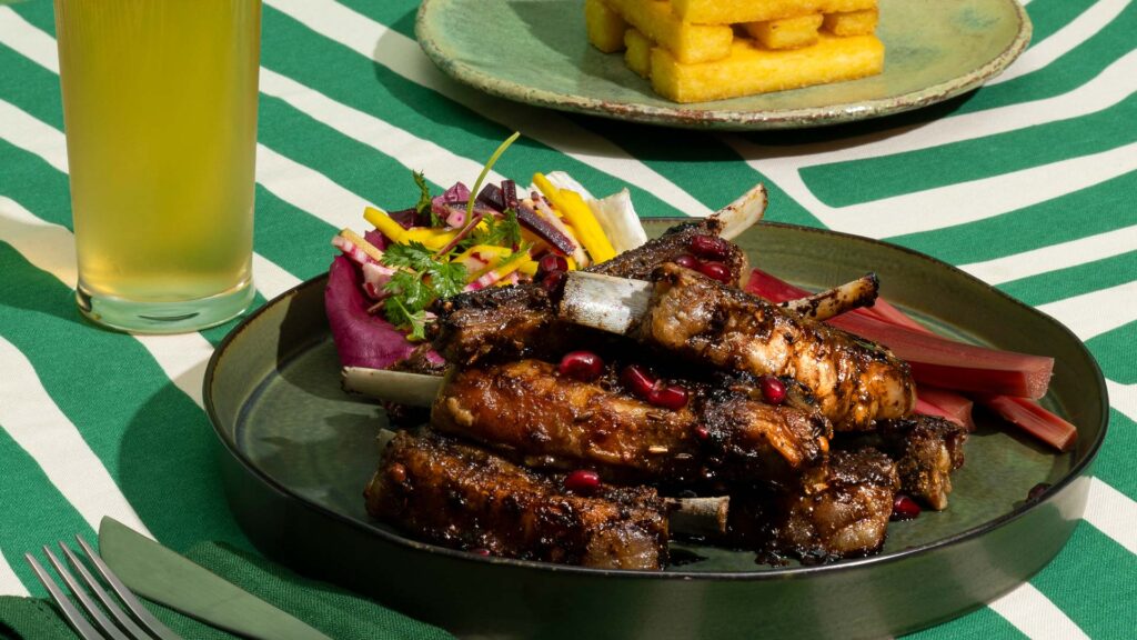 Black pepper, balsamic and pomegranate glazed lamb ribs 7 Sticky braised lamb ribs with pickled rhubarb, spring slaw and polenta chips.