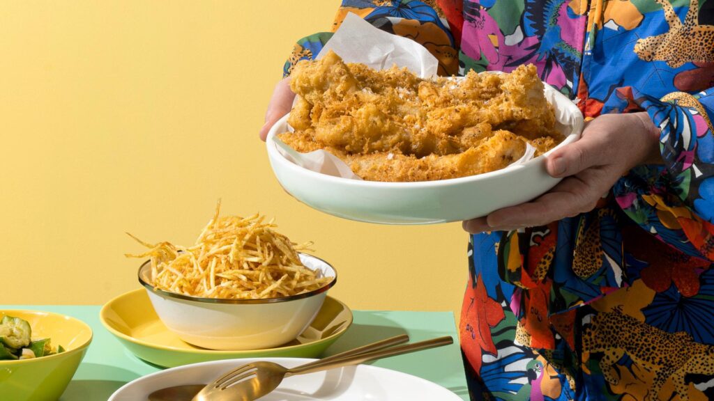 Crispy vadouvan spiced whiting 5 woman in crazy shirt serving crispy fried vadouvan whiting